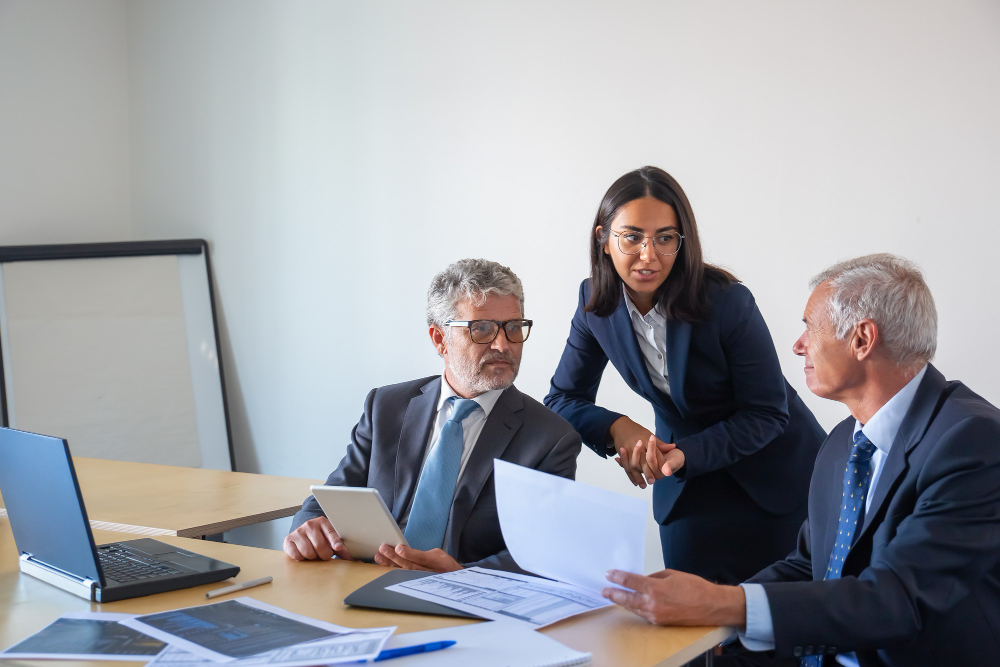 Attorneys meeting with a client to review case documents